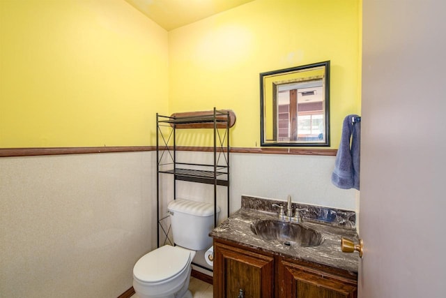 bathroom with toilet and vanity