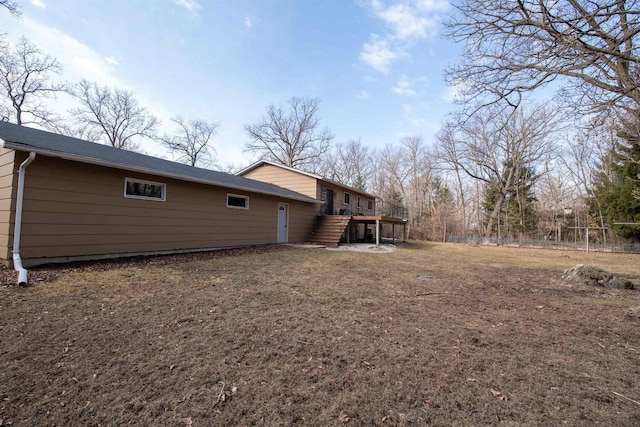 rear view of property featuring stairway, fence, and a wooden deck