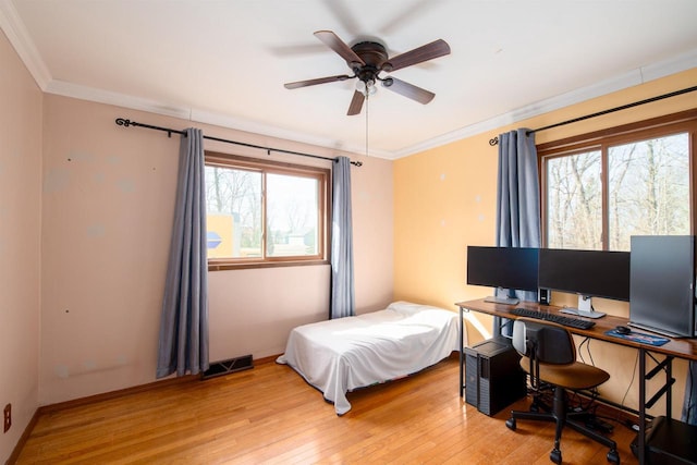 bedroom featuring light wood-type flooring, visible vents, ornamental molding, a ceiling fan, and baseboards