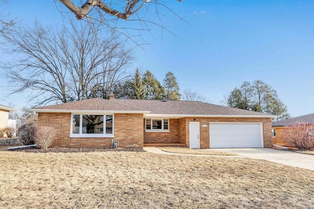 ranch-style home with roof with shingles, an attached garage, a chimney, concrete driveway, and brick siding