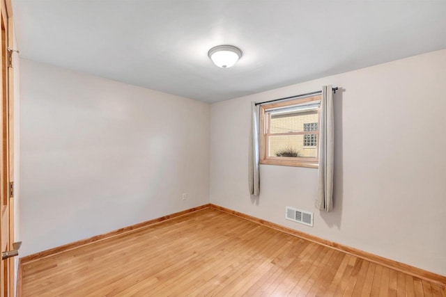 unfurnished room with visible vents, baseboards, and light wood-style floors