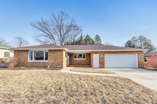 ranch-style house with a garage, brick siding, and concrete driveway