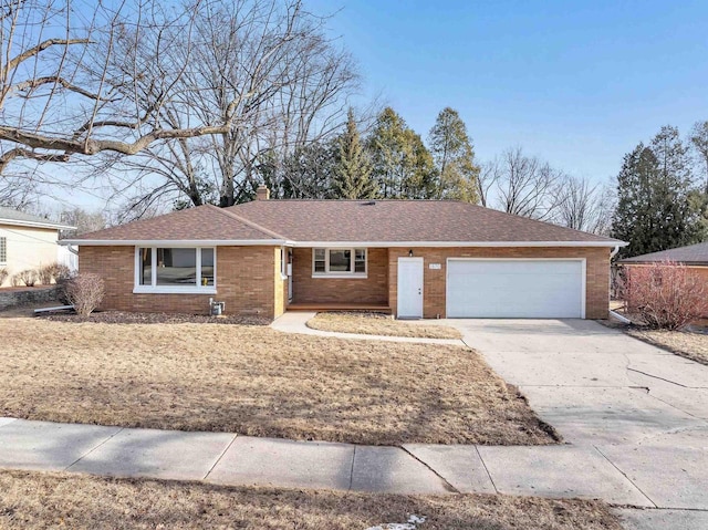 ranch-style home with brick siding, roof with shingles, a chimney, a garage, and driveway