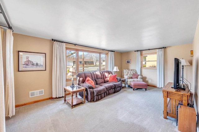 living room featuring visible vents, baseboards, and carpet flooring