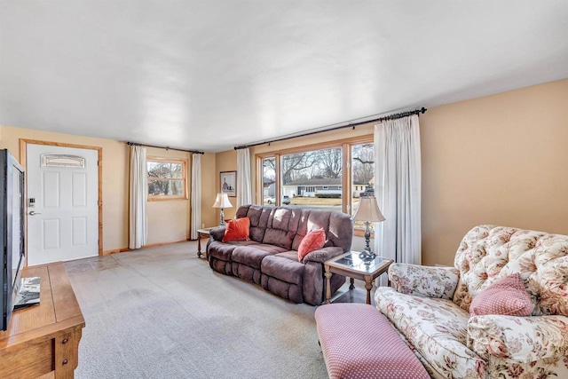 living room featuring a wealth of natural light and light colored carpet