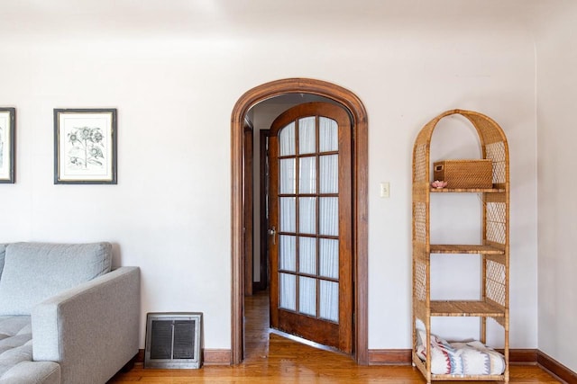 interior space with visible vents, baseboards, and wood finished floors