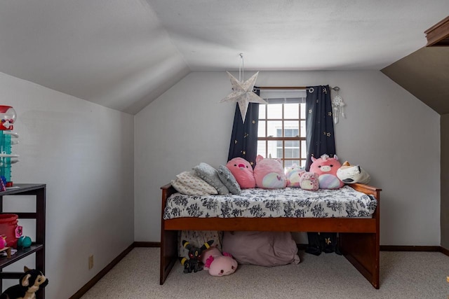 carpeted bedroom with lofted ceiling and baseboards