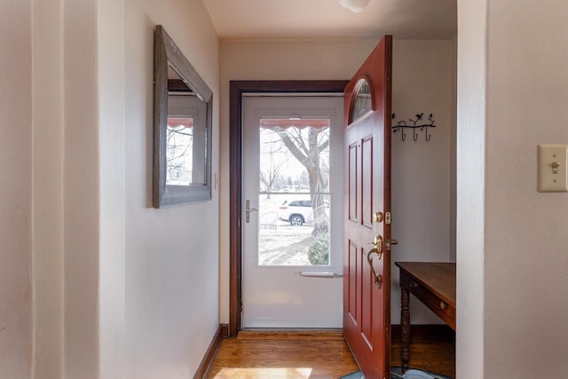 entryway with baseboards and light wood-style flooring