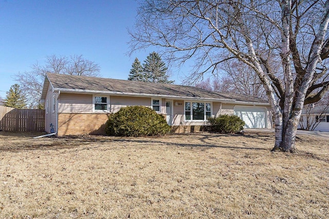 ranch-style house with a garage and fence