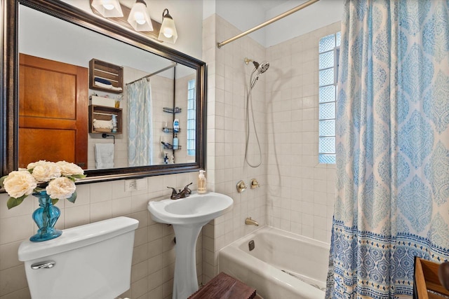 full bathroom with shower / tub combo with curtain, tile walls, and toilet