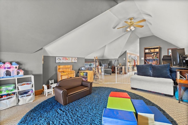 recreation room with vaulted ceiling, a ceiling fan, and carpet floors