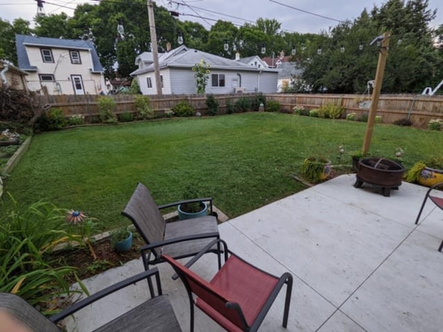 view of yard featuring a patio area, fence, and an outdoor fire pit