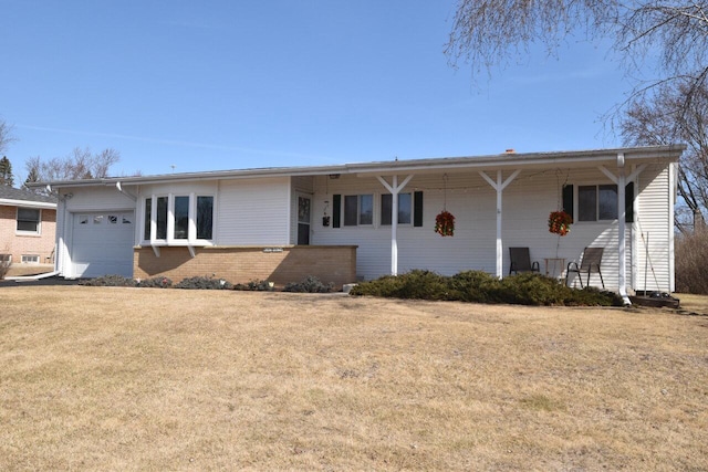 ranch-style home with a garage, brick siding, and a front yard