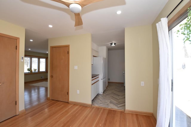 unfurnished room with recessed lighting, light wood-style flooring, baseboards, and ceiling fan