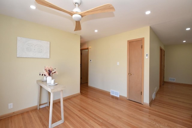 corridor featuring recessed lighting, visible vents, baseboards, and light wood finished floors