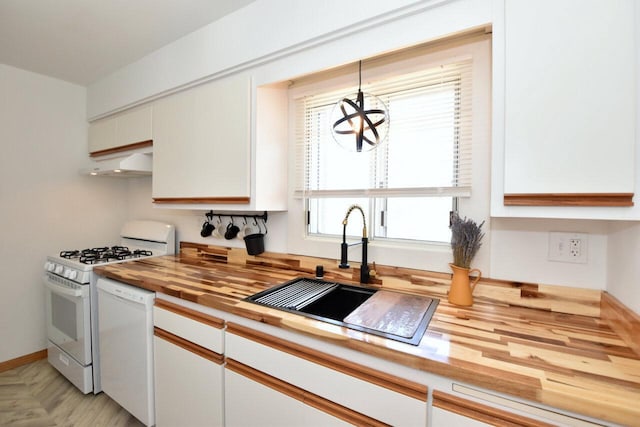 kitchen featuring a sink, wood counters, under cabinet range hood, white appliances, and a chandelier