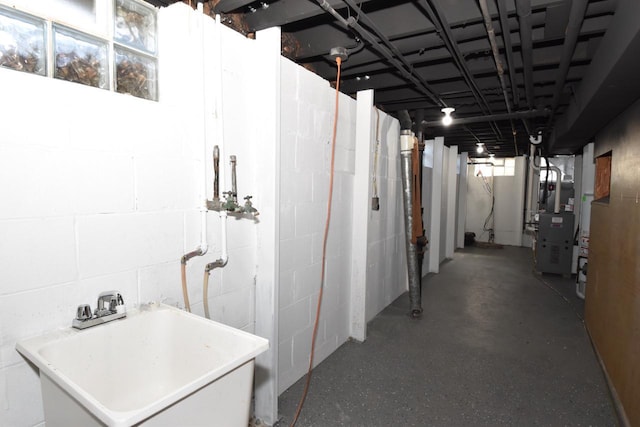 basement featuring a sink and heating unit