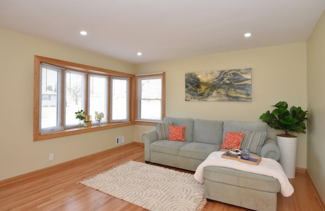 living room featuring recessed lighting, wood finished floors, visible vents, and baseboards