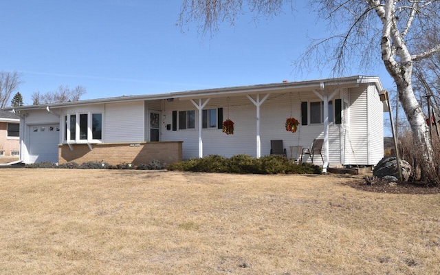 ranch-style home with brick siding, an attached garage, and a front yard