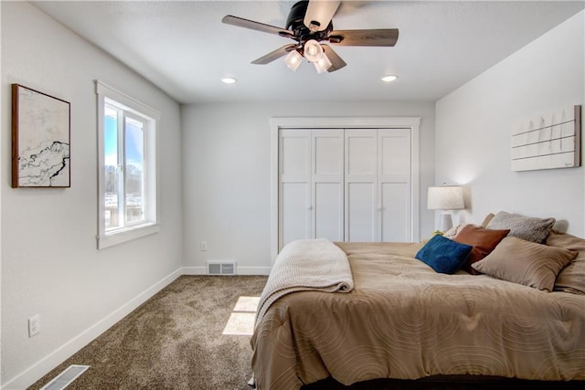 bedroom featuring visible vents, baseboards, carpet floors, and a closet