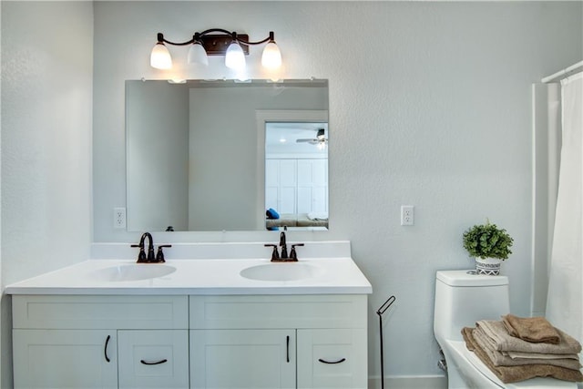 full bath featuring double vanity, toilet, and a sink