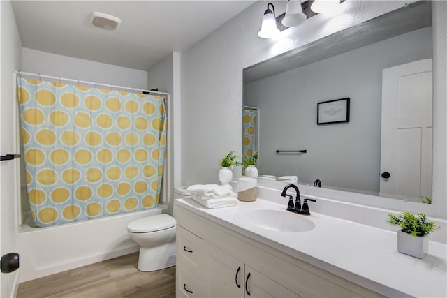 full bathroom featuring toilet, shower / bath combo, wood finished floors, and vanity