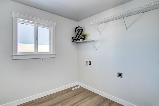 laundry area featuring hookup for a washing machine, wood finished floors, baseboards, hookup for an electric dryer, and laundry area