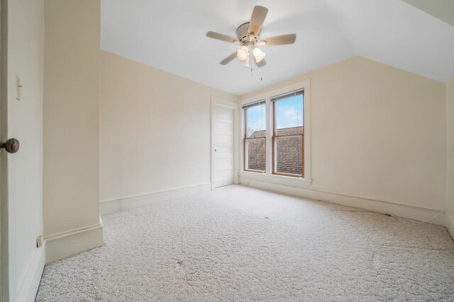 bonus room with lofted ceiling, carpet flooring, baseboards, and ceiling fan