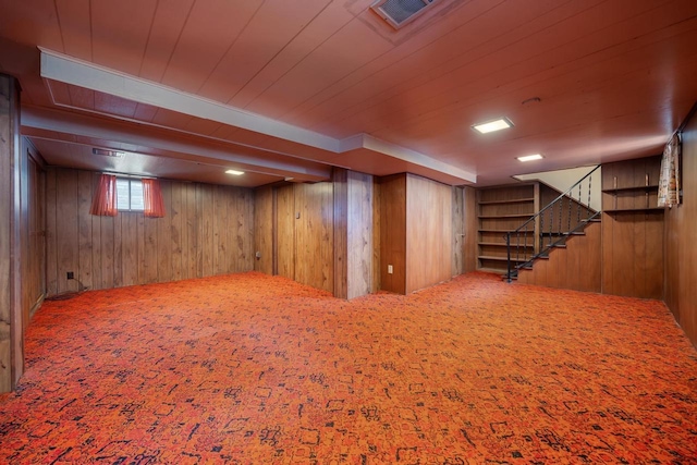 basement with visible vents, carpet floors, wooden ceiling, wood walls, and stairs