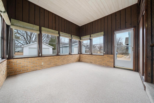 unfurnished sunroom featuring lofted ceiling and wooden ceiling