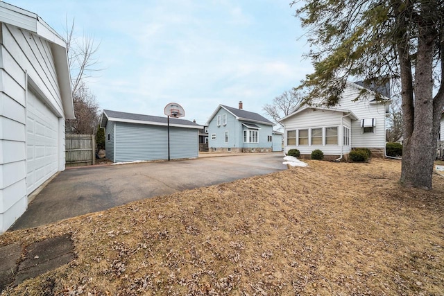 exterior space with driveway and fence