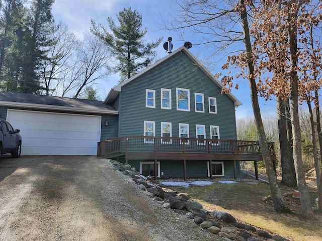 view of front of house with a garage, a deck, and dirt driveway