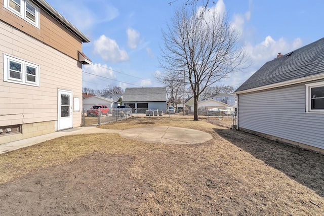 view of yard featuring a patio area, fence, and a residential view