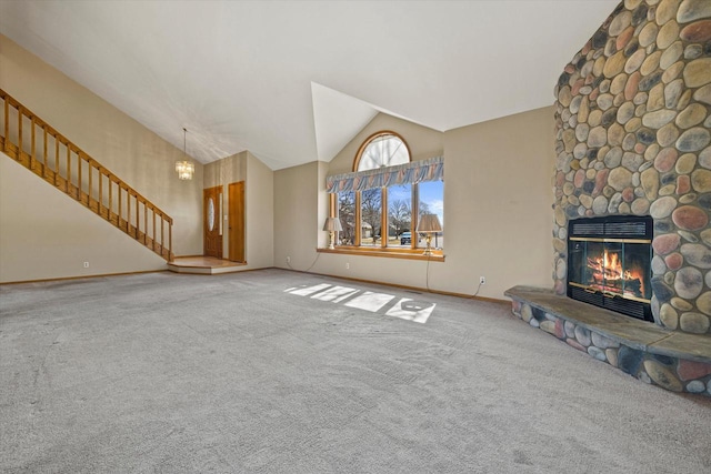 unfurnished living room featuring baseboards, carpet floors, high vaulted ceiling, and a fireplace