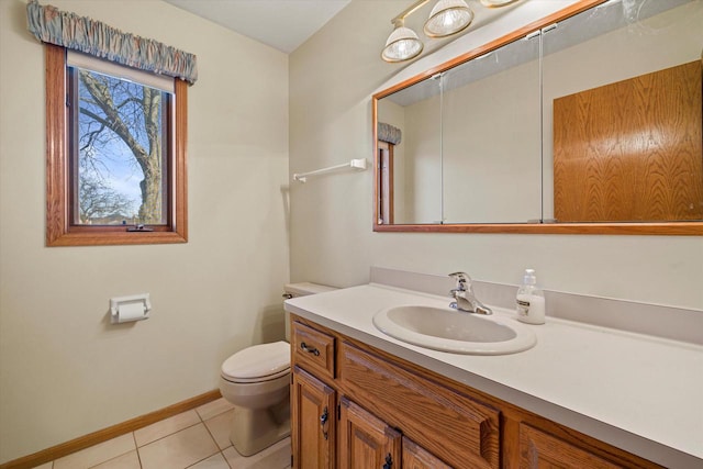 bathroom with tile patterned flooring, toilet, vanity, and baseboards