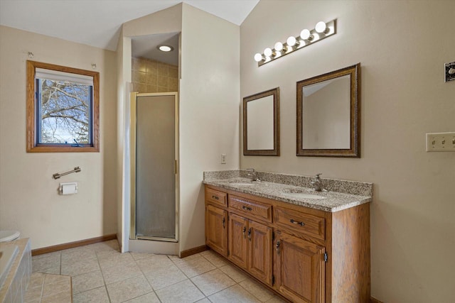 full bath featuring a sink, a stall shower, and tile patterned floors