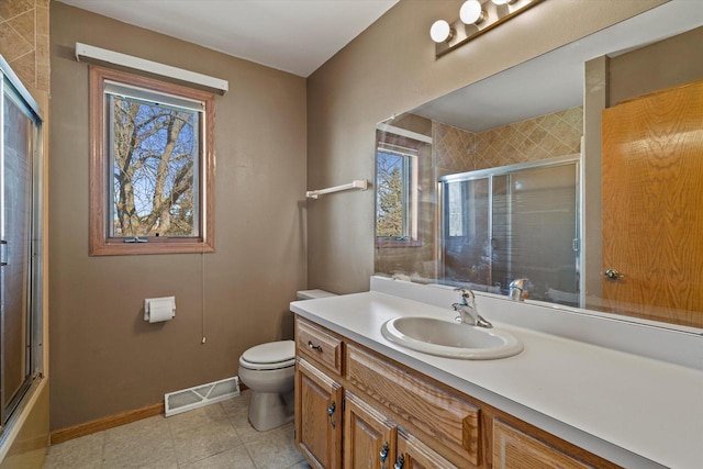 bathroom featuring vanity, baseboards, visible vents, tile patterned flooring, and toilet