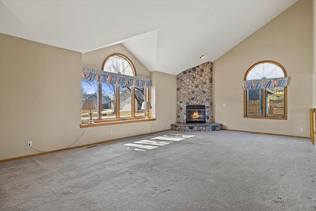 unfurnished living room featuring a fireplace, high vaulted ceiling, and carpet