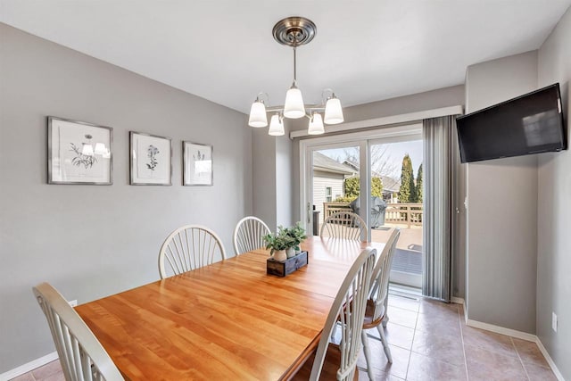 dining room with light tile patterned floors, baseboards, and a chandelier