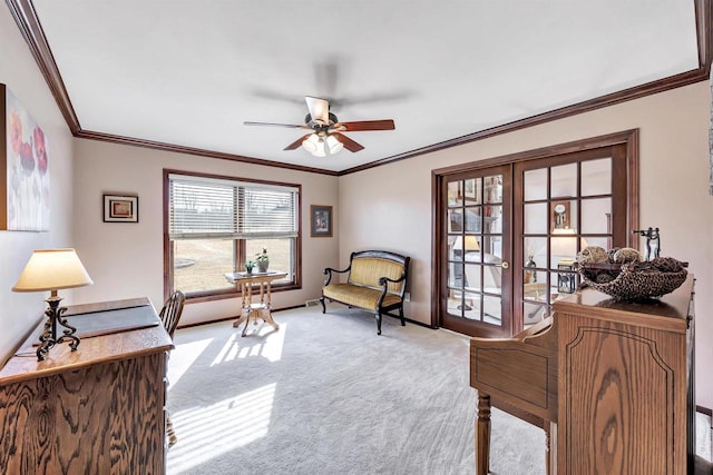 sitting room with baseboards, ceiling fan, ornamental molding, french doors, and carpet flooring