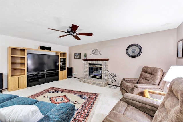 carpeted living room featuring a fireplace and a ceiling fan