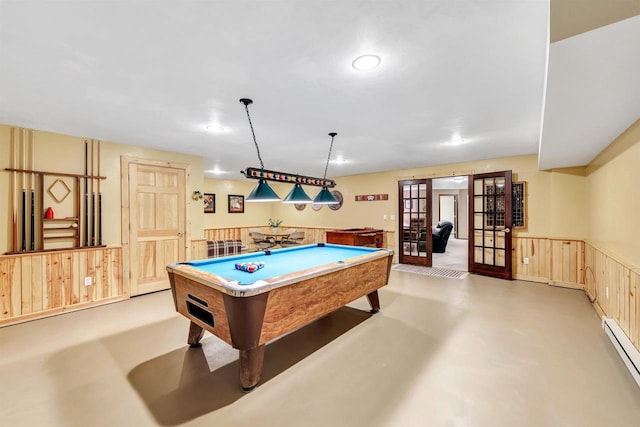 playroom featuring billiards, finished concrete flooring, french doors, wainscoting, and a baseboard heating unit