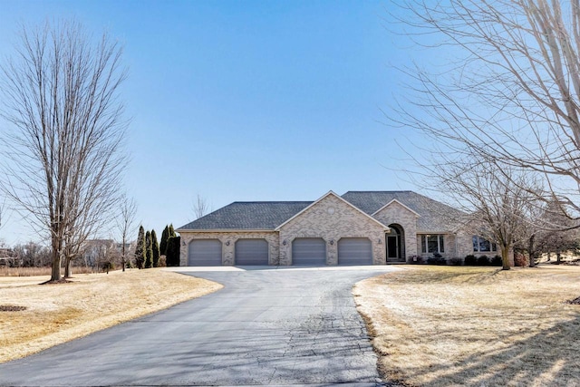 french provincial home with aphalt driveway, an attached garage, and a shingled roof