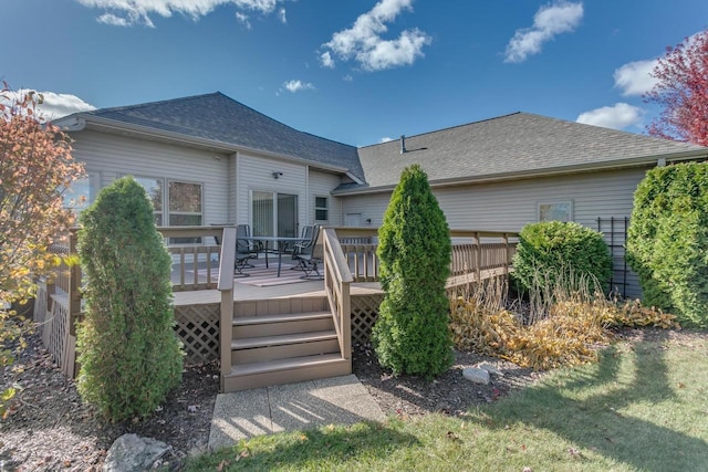 rear view of house with a deck and a shingled roof