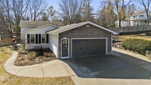 view of front of house with fence and a garage