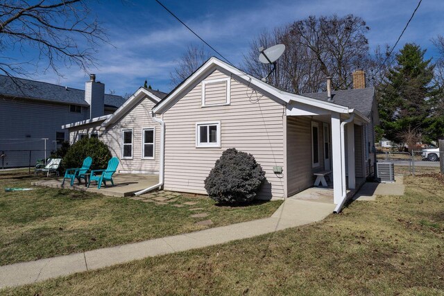 exterior space with a yard, fence, a chimney, and a patio area