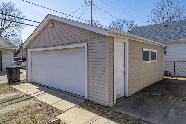 detached garage featuring fence