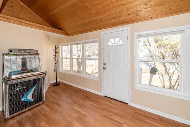 foyer with wooden ceiling, wood finished floors, baseboards, and vaulted ceiling