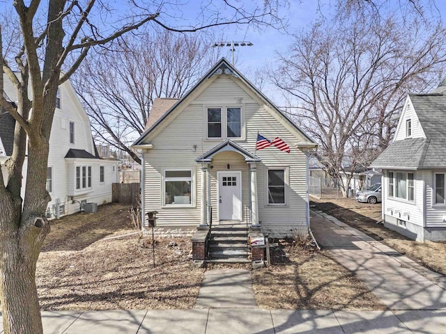 view of front of house featuring central AC unit and fence