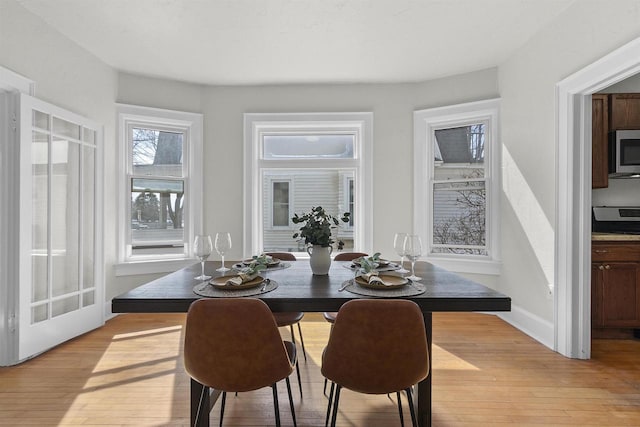 dining area featuring light wood-type flooring